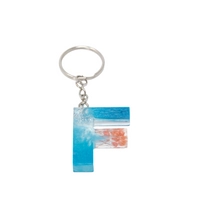 Resin Keychain with Blue Glitter and Peach Fried Flowers in the Shape of the Letter F