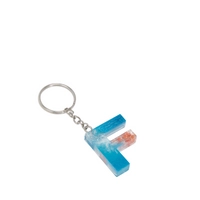 Resin Keychain with Blue Glitter and Peach Fried Flowers in the Shape of the Letter F