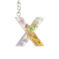 Resin Keychain with Dried Colorful Flowers in the Shape of the Letter X