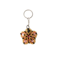 Key Chain In The Form of a Red Butterfly Surrounded by Yellow and Black Beads