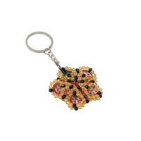 Key Chain In The Form of a Red Butterfly Surrounded by Yellow and Black Beads