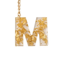 Initial Keychain letter M - Made of Transparent Resin with Shiny Golden Pieces 