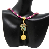 Handmade Fuchsia Beaded Necklace with a Golden Hamsa Hand Pendant