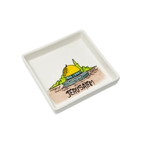 A square white dish decorated with an elaborate hand-painted drawing of the city of Jerusalem and the Dome of the Rock