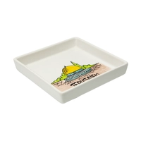 A square white dish decorated with an elaborate hand-painted drawing of the city of Jerusalem and the Dome of the Rock