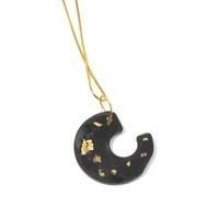 Distinctive Gold Necklace: A Thin Gold Chain with A Black Spiral Pendant