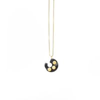 Distinctive Gold Necklace: A Thin Gold Chain with A Black Spiral Pendant