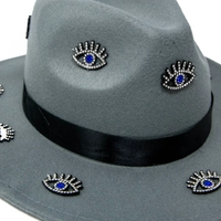 Women's gray fedora hat designed with a black satin ribbon and small eye patches