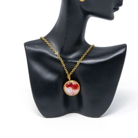 A stylish accessories set with red rose in resin and metal - necklace and earrings in red color.