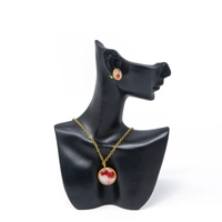 A stylish accessories set with red rose in resin and metal - necklace and earrings in red color.