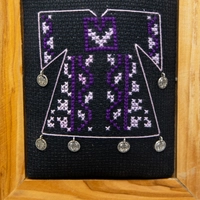 A wooden frame embroidered from the inside in the shape of a dress - purple color