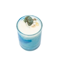 Candle in a Glass Decorated with Seashells, Evoking Calm Coastal Vibes