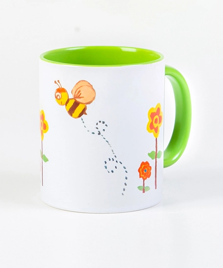 White & Green Ceramic Mug Featuring Bees Drawings Inspired by Children's Art at KHCC