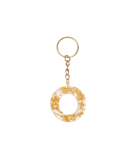 Keychain made of transparent resin decorated with shiny golden pieces - letter O