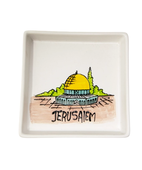 A square white dish decorated with an elaborate hand-painted drawing of the city of Jerusalem and the Dome of the Rock