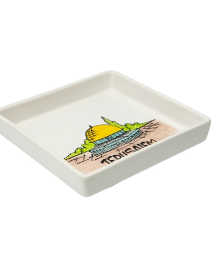 A square white dish decorated with an elaborate hand-painted drawing of the city of Jerusalem and the Dome of the Rock