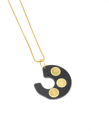 Distinctive Gold Necklace: A Thin Gold Chain with A Black Spiral Pendant