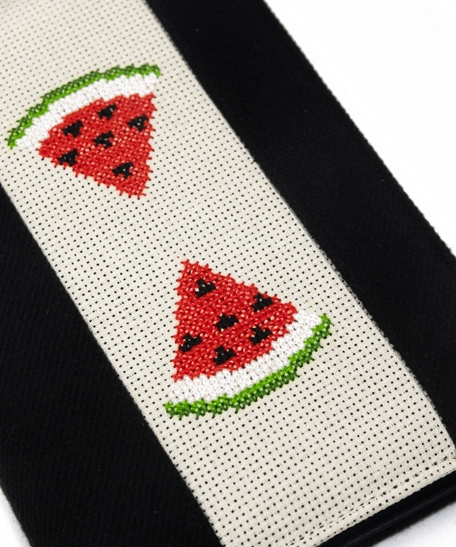 An elegant notebook with hand embroidery featuring a drawing of two watermelon pieces!