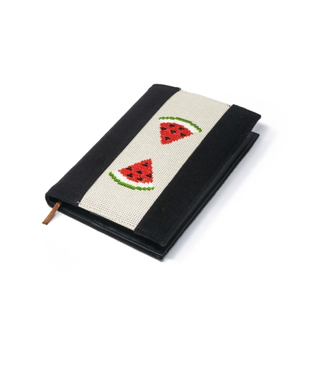 An elegant notebook with hand embroidery featuring a drawing of two watermelon pieces!