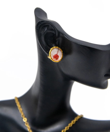 A stylish accessories set with red rose in resin and metal - necklace and earrings in red color.