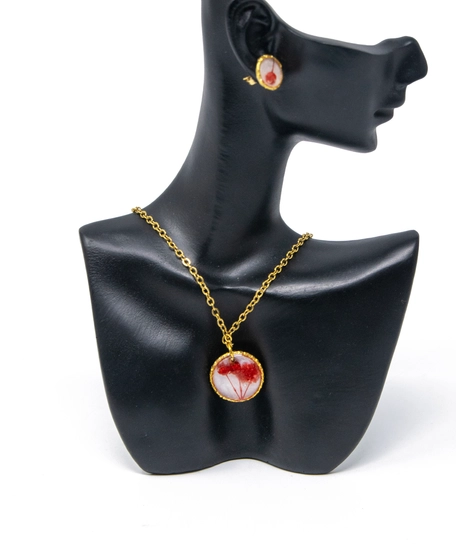 A stylish accessories set with red rose in resin and metal - necklace and earrings in red color.